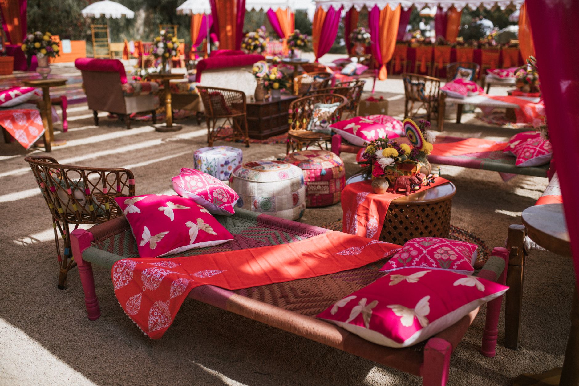 Colorful outdoor lounge area with vibrant textiles and seating arrangement at an event. — Betrouwbare Online Wedden E Mma