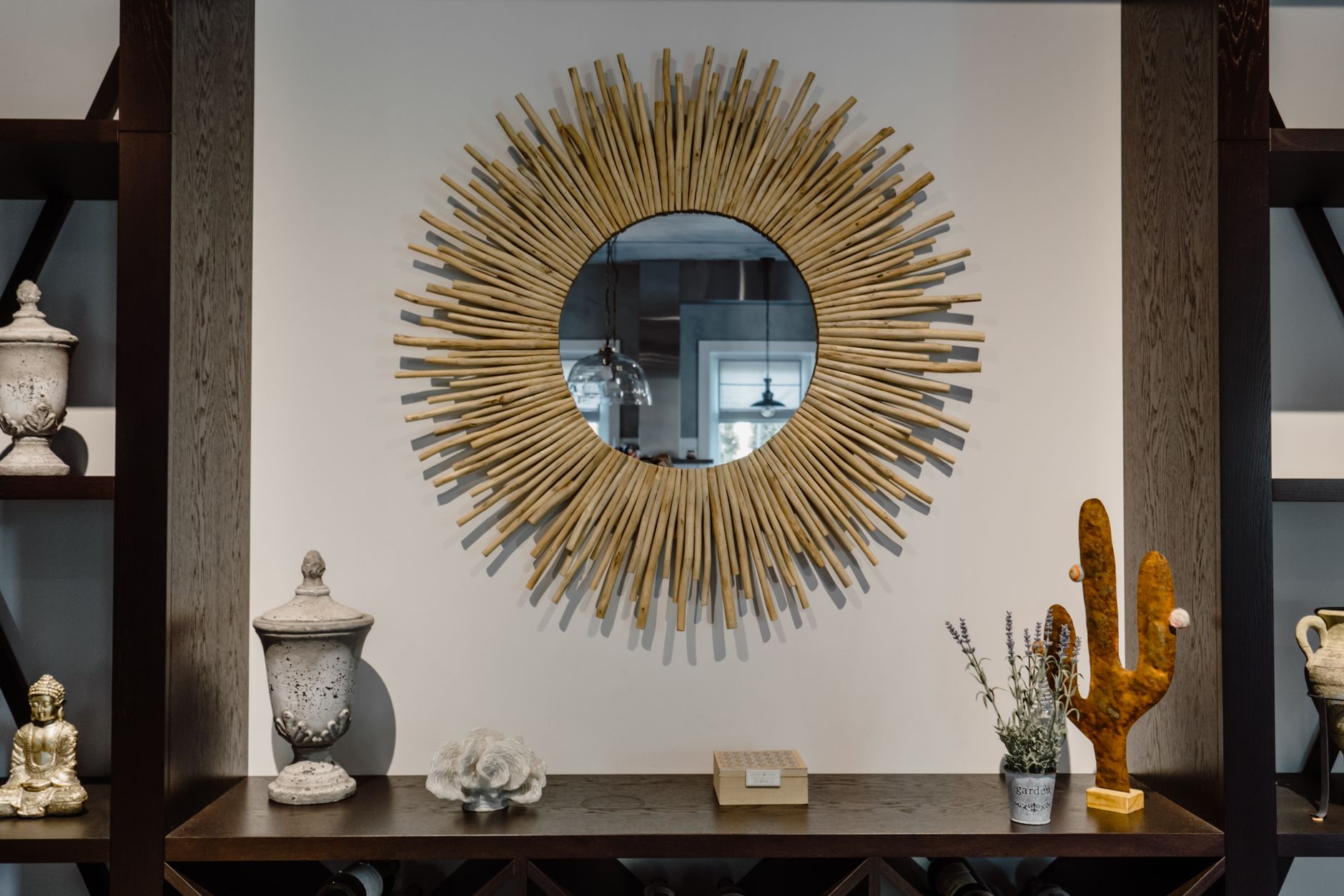 Contemporary living room featuring a unique sunburst mirror and chic decor accents. — Casa De Apuestas Deportivas Barcelona