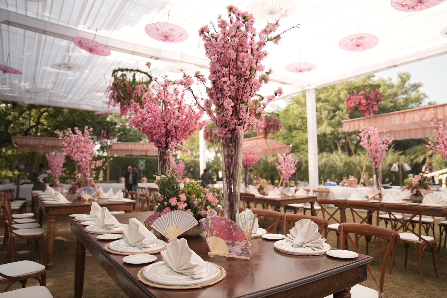 Stunning outdoor Indian wedding setup with pink floral decor and traditional fans. — Fastest Withdrawal Casinos
