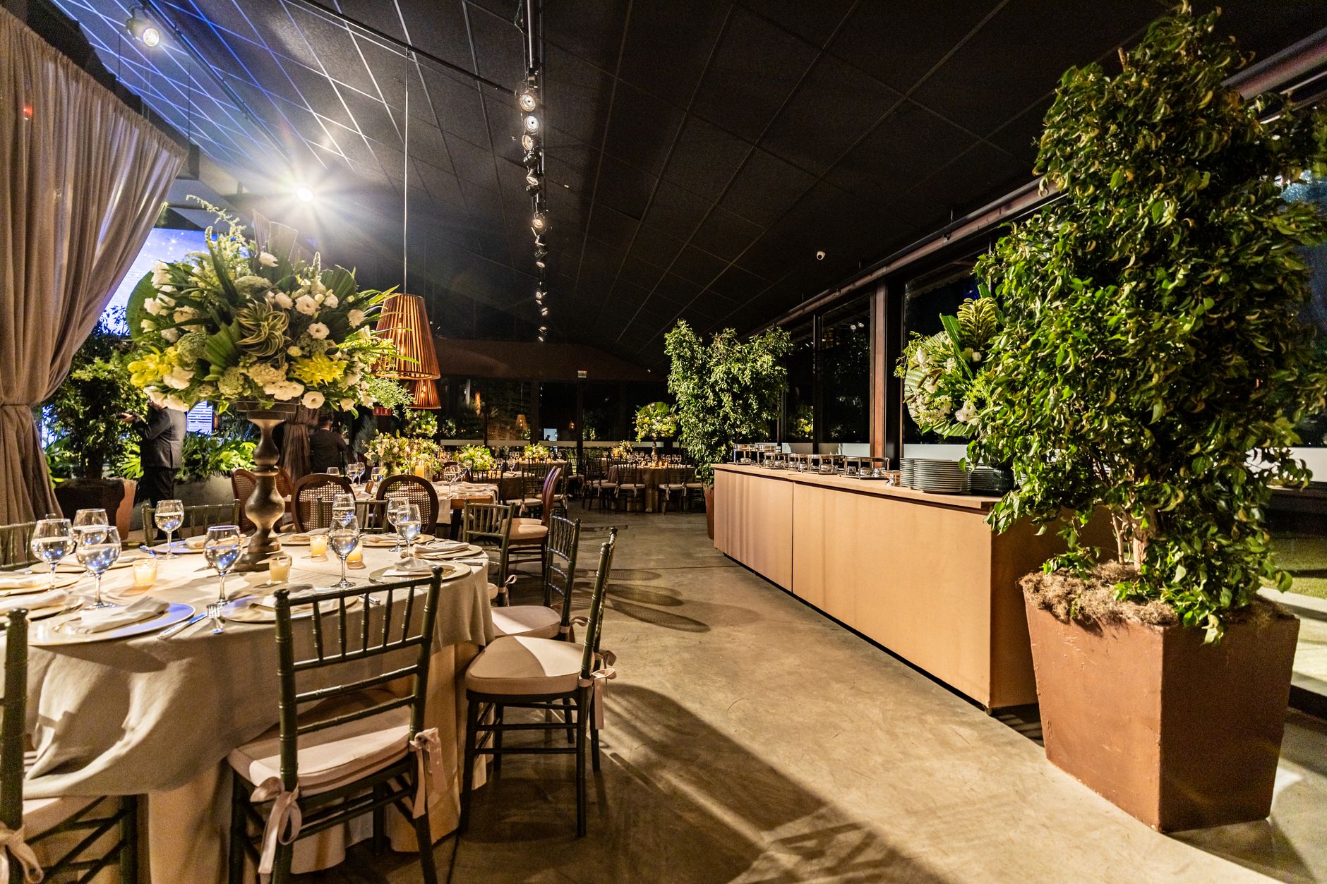 Chic indoor dining area with floral arrangements, elegant table settings, and warm lighting. — Uruguay Vs Colombia Apuestas I